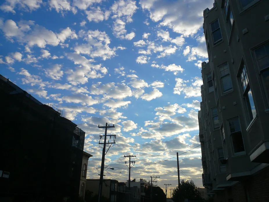 Small puffs on altocumulus clouds above an urban location with buildings and powerlines