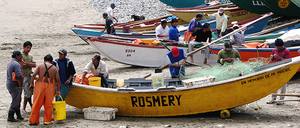 Peruvian fishermen and boats on the beach.