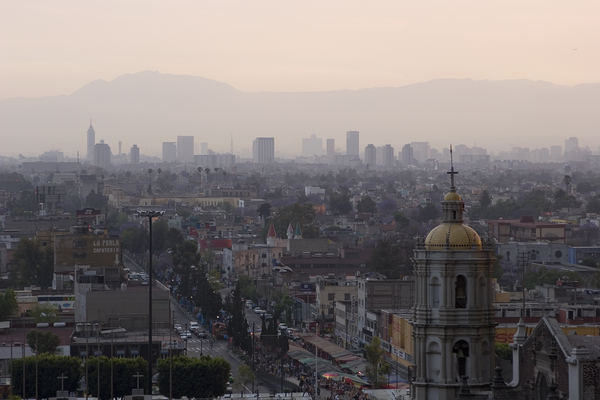 Air pollution in Mexico City causes hazy skies that block sunlight from reaching the ground.