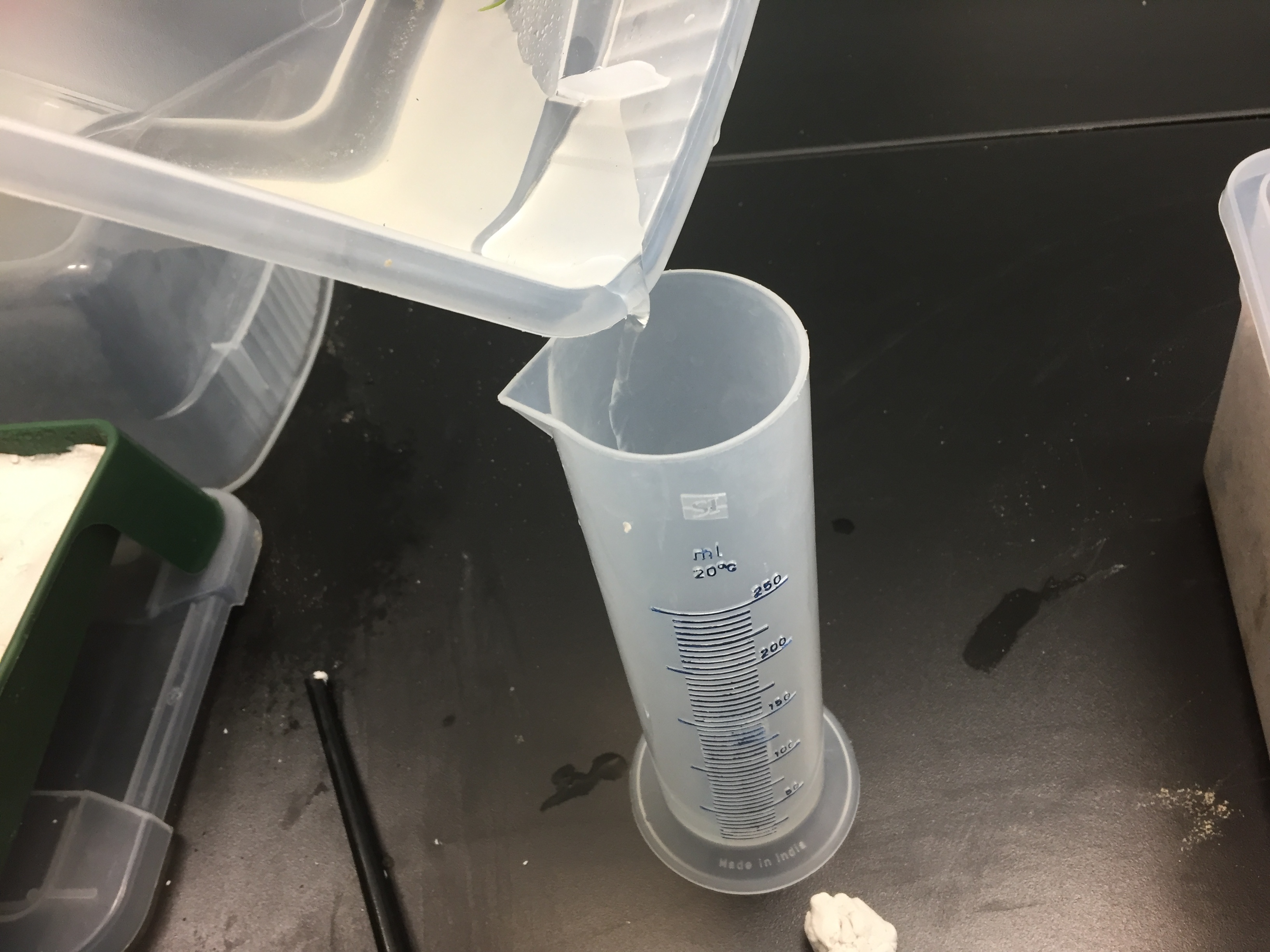 A photo showing how students can measure the volume of water that passed through their stream table by pouring the water collected into a graduated cylinder.