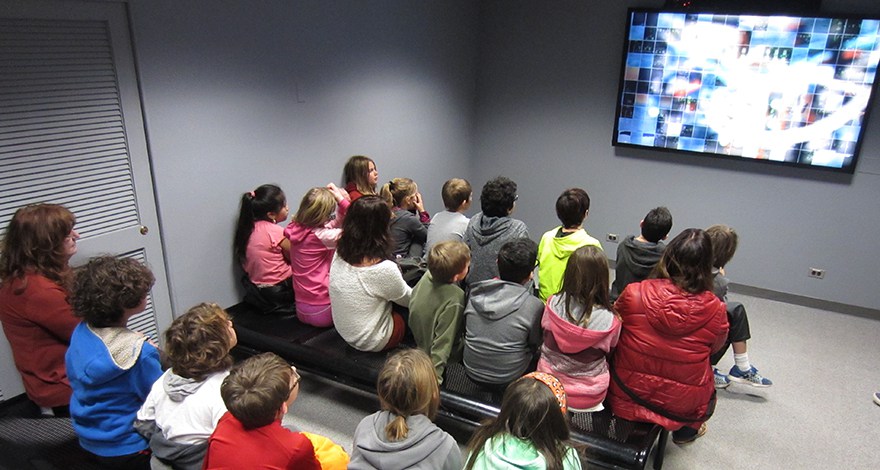 Students watch weather and climate videos in the NCAR Theater