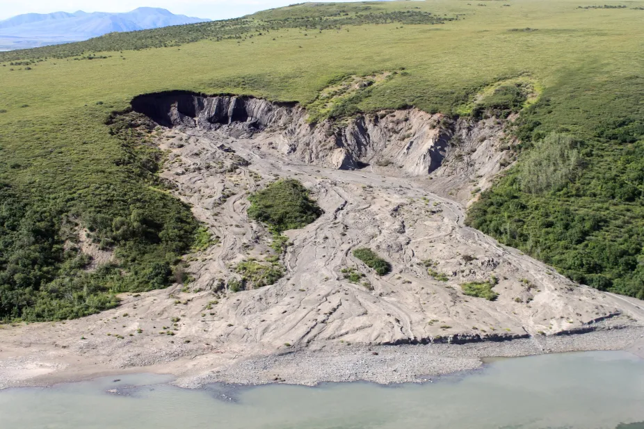 A scar in the tundra landscape caused by a slump associated with thawing permafrost.