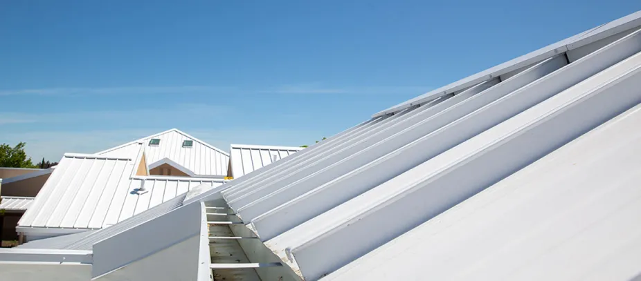 White metal roofs under a blue sky