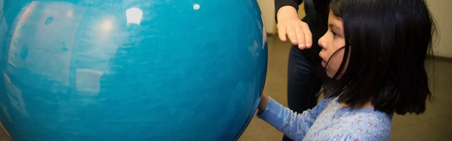 A student gazing into the blue turbulent orb. 