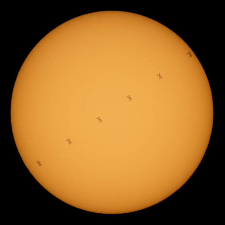 The Sun with time lapse images of the International Space Station superimposed in an arc from left to right.