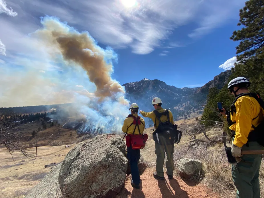 Fire fighters assess the damage of the NCAR fire, March 26, 2022