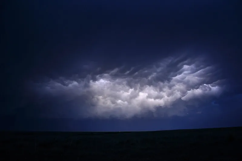 photo of cloud to cloud (also called intracloud) illuminating thunderstorm clouds at nighttime