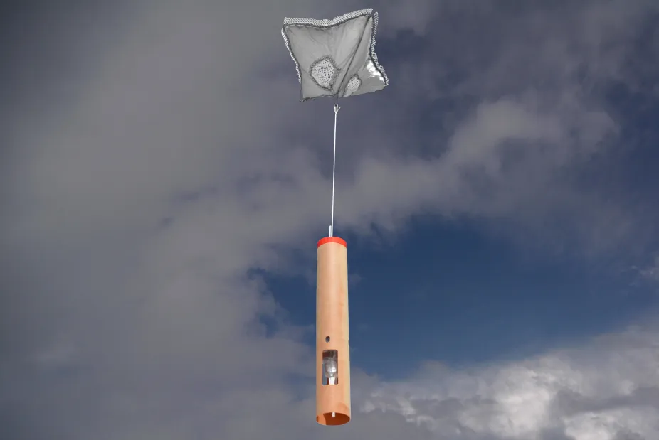 A dropsonde descending from a parachute
