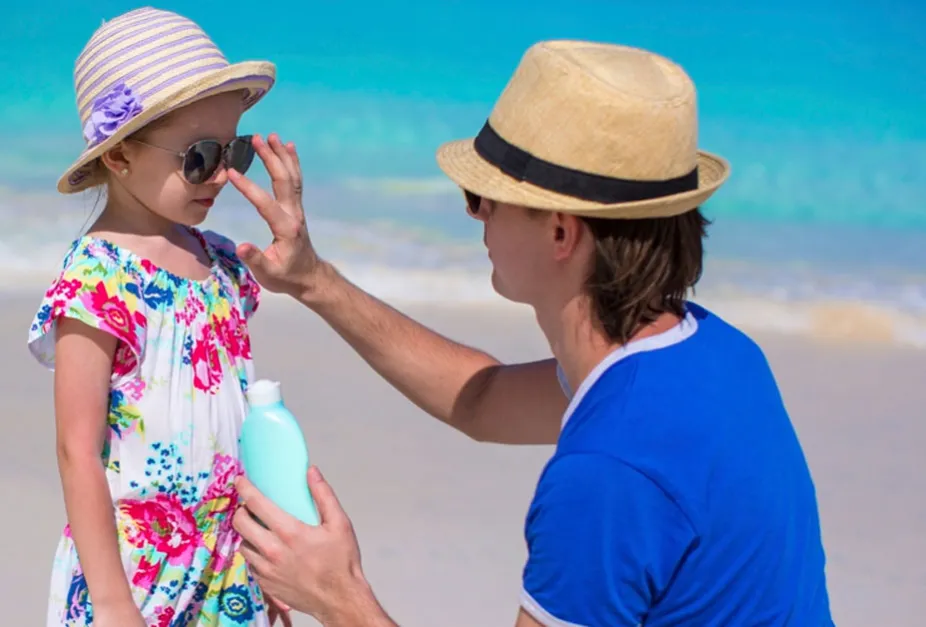 photo of a parent applying sunscreen to protect a child's skin from ultraviolet radiation