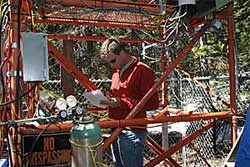 Man looking at scientific equipment outdoors