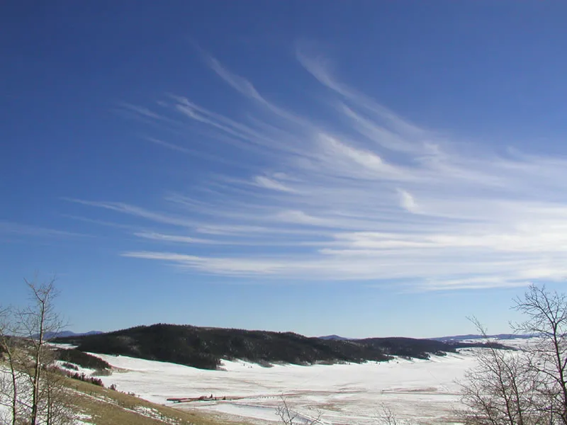 Cirrus clouds over a winter landscape