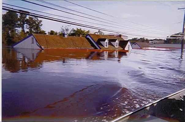 A flooded house, with water reaching the rooftop