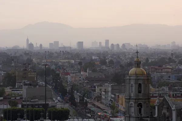 Air pollution in Mexico City causes hazy skies that block sunlight from reaching the ground.