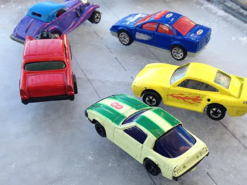 Several toy cars on ice