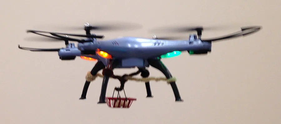 UAV delivering a payload, showing skyhook with basket.