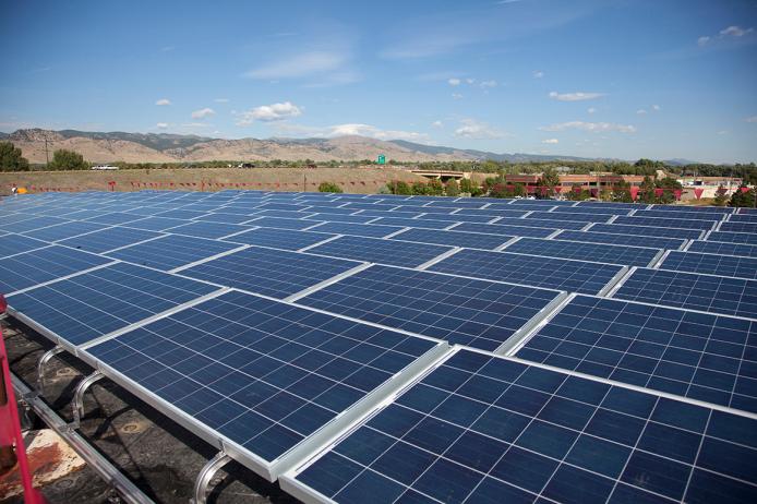 This is an image of large field solar panels arranged in rows, tilted slightly towards the Sun.