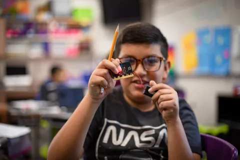 A student working with electronics during a STEM CC project