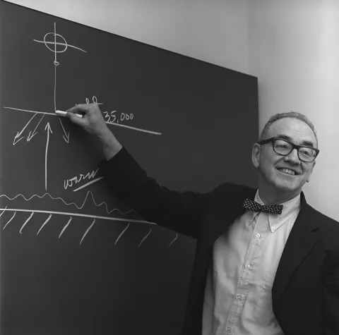 Walter Orr Roberts teaching next to a blackboard