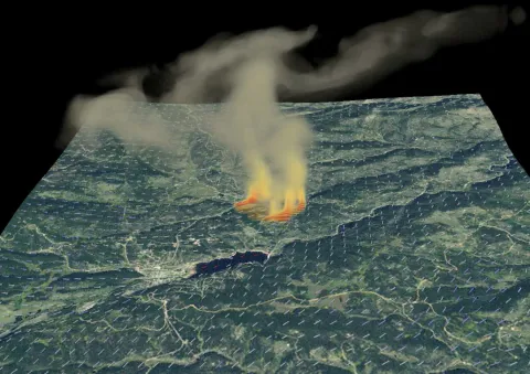 A computer model that simulates a fire indicating topography, wind direction and smoke emitting from a fire
