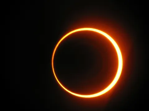 During an annular eclipse the dark Moon is surrounded by a bright ring of light from the Sun.
