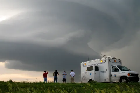 Scientists outside observing a storm