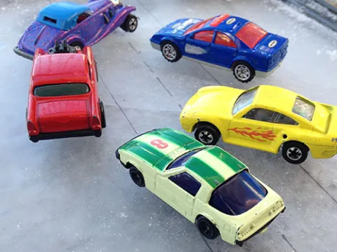 Several toy cars on ice
