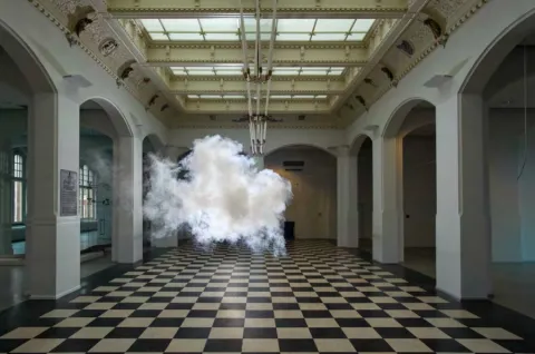A cloud floating in the middle of a museum room