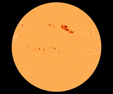Red sunspots on orange sun