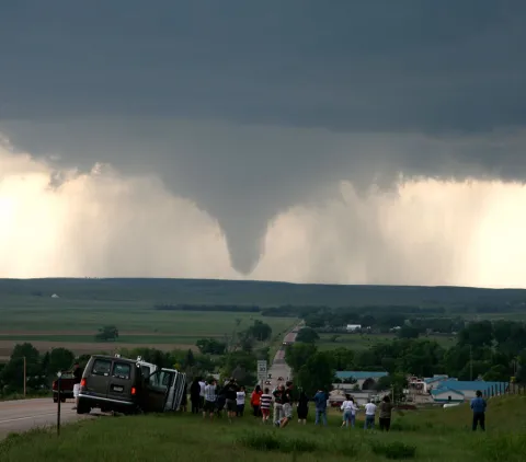 A crowd watches as a tornado form in Wyoming in June of 2009