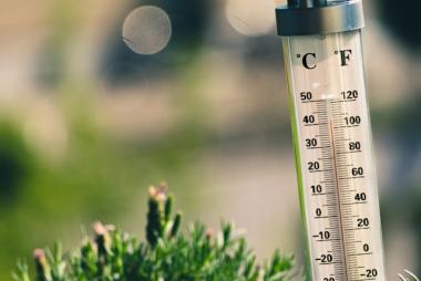 image of a thermometer outdoors on a hot day